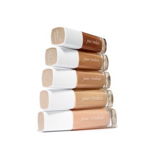 Stacked Jane Iredale foundation bottles in a range of inclusive skin tone shades