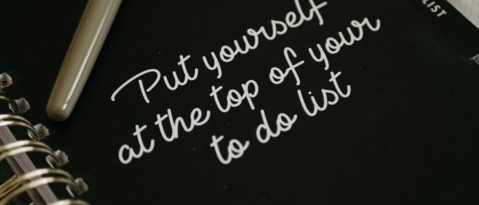 Notebook with the quote 'Put yourself at the top of your to-do list', inspiring self-care and wellness.
